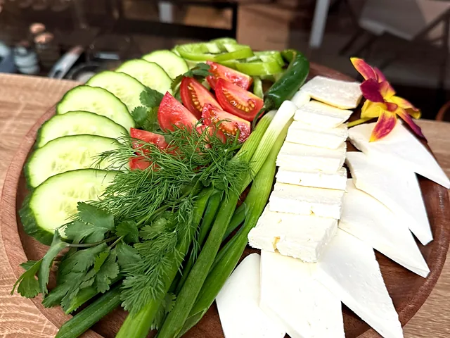 Avar salad — cheeses, herbs and fresh vegetables on a board