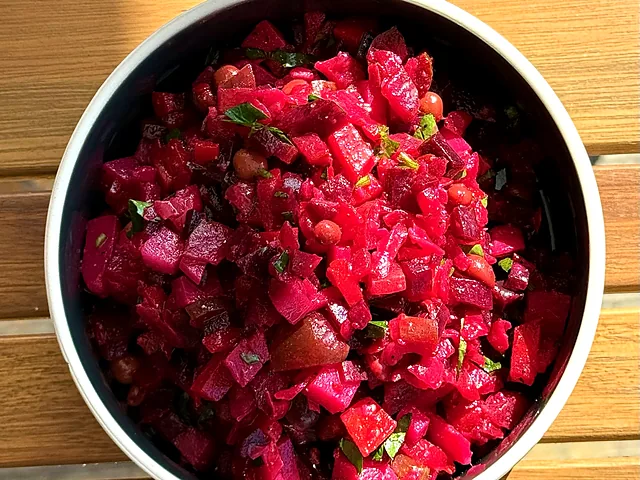 Beets salad with herbs in a white bowl