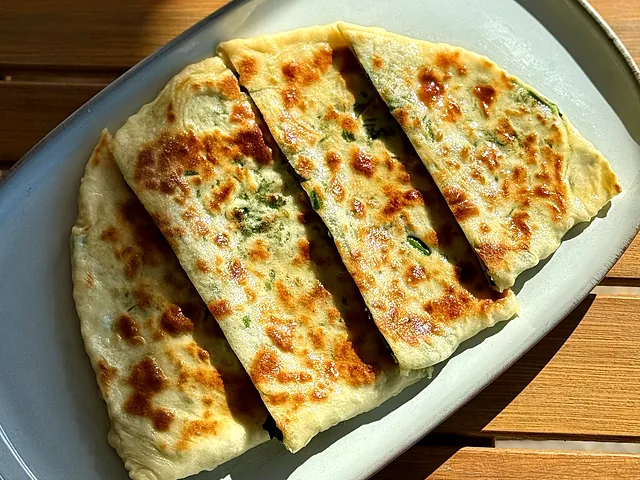 Chudu with a filling of mixed greens, cut into strips